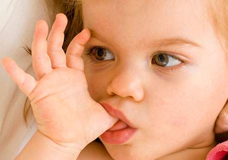 Toddler sucking thumb – prolonged thumb sucking habit beyond age 4 can affect dental and jaw development.